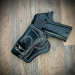 Black leather IWB holster with 10-degree cant showing molded fit and contrast stitching