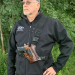 Brown handcrafted leather chest holster worn outdoors with adjustable shoulder and waist straps