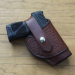Brown Tooled Leather Thumb Break Holster with basketweave panel and snap retention strap
