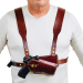 Brown leather chest holster harness worn on chest showing secure field carry position