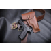 displayed with matching leather belt and handgun on black leather surface
