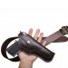 Vintage brown leather OWB belt holster with classic stitched design shown with matching leather belt