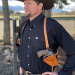 Custom brown leather vertical shoulder holster worn under western shirt with adjustable harness