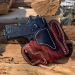 Mahogany woodgrain OWB leather belt holster showing molded fit and reinforced stitching