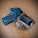 Walnut leather IWB holster with 10-degree cant and metal belt clip on wooden surface