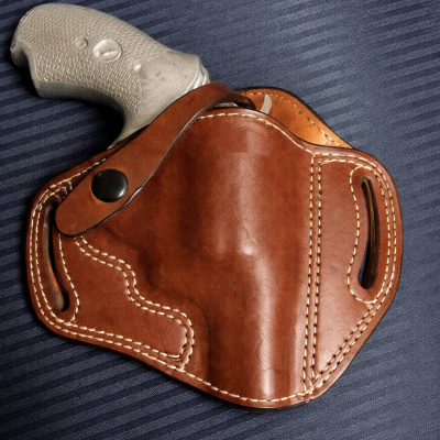 Brown Leather OWB Thumb Break Holster in smooth Standard Saddle Brown vegetable oiled leather with white stitching, belt slots, and a one way snap retention strap.