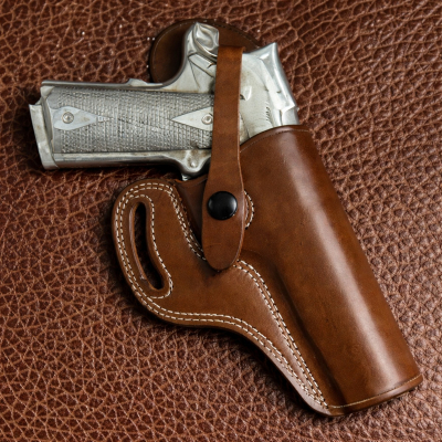 Brown Leather OWB Thumb Break Strap in smooth Standard Saddle Brown vegetable oiled leather with a one way safety snap attached to an outside the waistband holster.