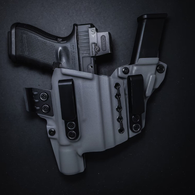 Light-bearing appendix IWB Kydex holster showing adjustable retention hardware and belt clips