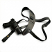Black leather shoulder holster with adjustable straps and reinforced stitching, laid flat on white background