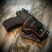 Black leather IWB clip holster with molded profile and contrast stitching for concealed carry