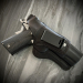 Black leather IWB holster with thumb break retention and metal belt clip