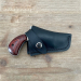 Black Leather Snap Belt Holster worn on a brown belt with snap retention strap secured over a compact revolver grip.