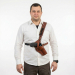 Brown Leather Forester Chest Holster worn on the chest, showing front view of adjustable leather harness and secure handgun carry
