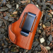 Brown Leather IWB Holster With Clip detail image showing molded leather body and stitched edge on outdoor ground