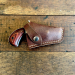 Brown leather pocket revolver snap holster front view with retention strap