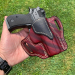 Mahogany woodgrain leather OWB holster showing molded fit and belt slots