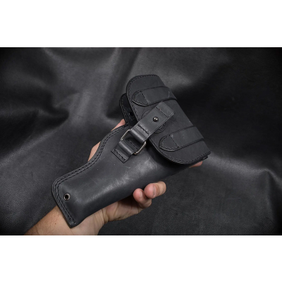 Black Leather Patrol Flap Holster held in hand showing full cover flap and enclosed field carry design