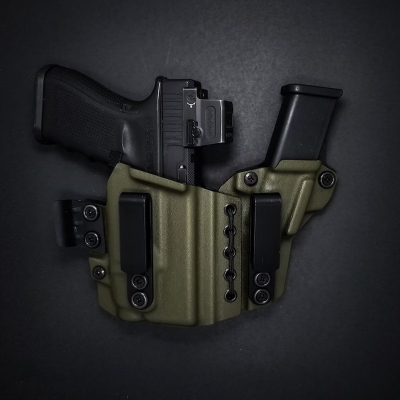Light-bearing appendix carry Kydex holster in olive color showing adjustable retention and belt clips