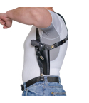 Black leather shoulder holster worn under clothing with revolver in vertical carry position