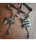 Black leather shoulder holster set with holster and dual magazine pouches laid flat on brown surface