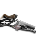 Black leather vertical shoulder holster laid flat, showing smooth leather finish and reinforced construction