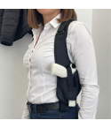 Black shoulder holster side view with underarm carry on white shirt