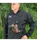 Brown handcrafted leather chest holster worn outdoors with adjustable shoulder and waist straps
