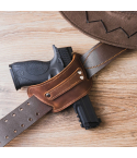 Brown leather belt slide holster mounted on a leather belt, showing open-top design and reinforced stitching for secure everyday carry