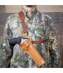 Brown leather chest holster worn on camo jacket showing cross chest handgun carry