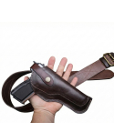 Vintage brown leather OWB belt holster with classic stitched design shown with matching leather belt