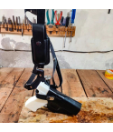 Leather chest holster displayed on workbench showing holster body and harness assembly