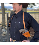 Custom brown leather vertical shoulder holster worn under western shirt with adjustable harness