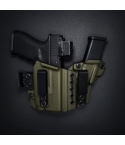 Light-bearing appendix carry Kydex holster in olive color showing adjustable retention and belt clips