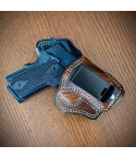 Walnut leather IWB holster with 10-degree cant and metal belt clip on wooden surface