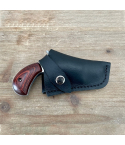 Black Leather Snap Belt Holster worn on a brown belt with snap retention strap secured over a compact revolver grip.
